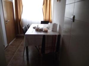a table in a room with a white table cloth at Casa Correia in Monte Gordo