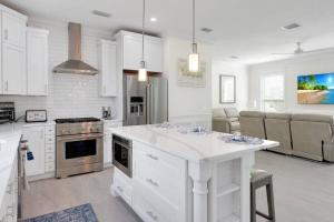 a kitchen with white cabinets and a white counter top at AMI Beach Oasis in Bradenton Beach