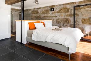 a bedroom with a large white bed with orange pillows at Renoviertes Landhaus Inmitten Der Natur In Tondela in Tondela