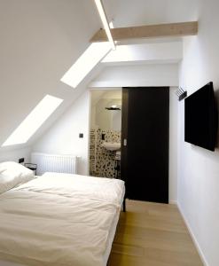 a bedroom with a white bed and a black door at Ferienwohnung In Söchau Mit Terrasse Und Grill in Söchau