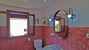 a bathroom with a sink and a mirror at Casa Número 6 in Válor +30 photos
