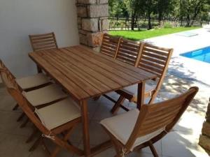 a wooden table and chairs on a patio at Villa Dubci in Grožnjan