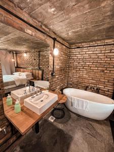 ein Badezimmer mit Badewanne und Waschbecken und ein Bett in der Unterkunft Monte Sião Château in Urubici + 37 Fotos