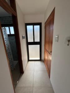 an empty hallway with a door and a window at Temporario Alfonso I in Santa Fe