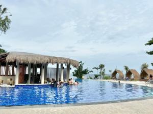 a group of people in the swimming pool at a resort at Family-Friendly Condo Unit in Lapu Lapu City
