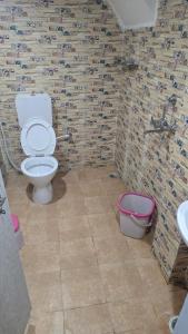 a bathroom with a toilet and a sink at Luxe Villa in Varanasi +8 photos
