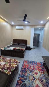 a bedroom with two beds and a rug at Luxe Villa in Varanasi