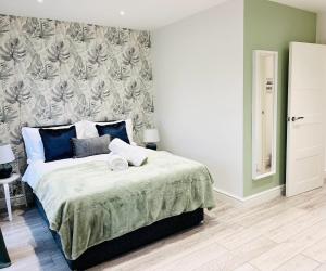 Schlafzimmer mit einem großen Bett in Blau und Weiß in der Unterkunft Stunning Apartment -Quick Access to Central London in Ealing