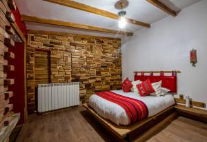 Un dormitorio con una cama y una pared de ladrillo. en Flamencos Altiplano Eco Hotel, en Ramaditas