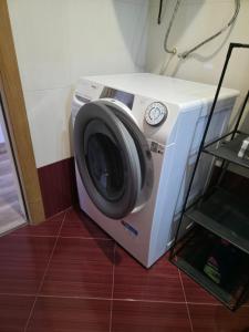 a washing machine sitting on the floor in a room at HomeViza in Yambol