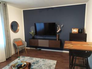 a living room with a flat screen tv on a wall at Apartment 17 in Kassel