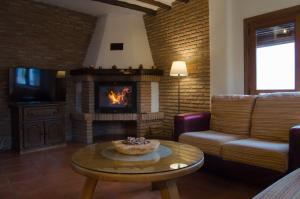 a living room with a couch and a fireplace at Casa Número 7 in Válor