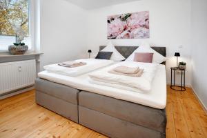 a large bed with two pillows on it in a room at Klostergarten in Grünstadt