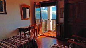 a room with a bed and a balcony with a view at Casa Número 5 in Válor