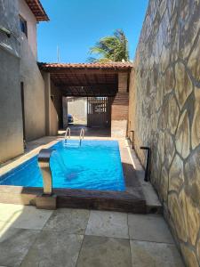 a swimming pool in front of a building at Sua casa no litoral III in Luis Correia