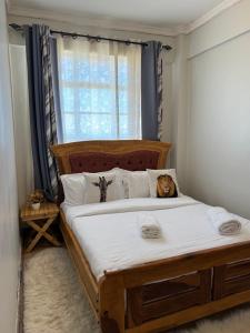 a bedroom with a bed with a cat laying on it at Chui by Rorric Safaris in Nanyuki