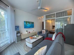 a living room with a couch and a table at Zuri Twin Sands Beach Properties - Malindi in Malindi