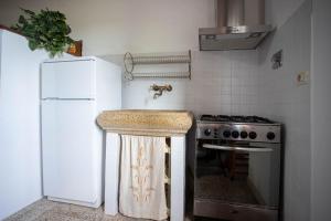 a kitchen with a sink and a stove at Enrica - Agriturismo La Valentina in Talamone +22 photos