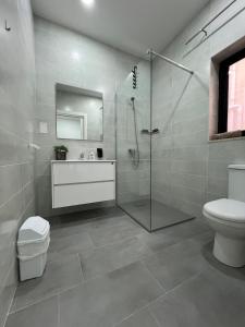 a bathroom with a shower and a sink and a toilet at Triton Mansion D26 - Entire Unit in St Paul's Bay +23 photos