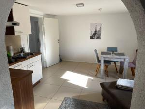 a kitchen with a table and a dining room at Appartment Schmidtner in Ansbach +2 photos