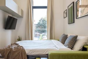 a bedroom with a bed and a window at Urban Oasis near Termini, Free Parking&Balcony, int10 in Rome