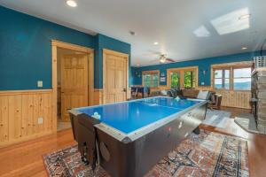 a pool table in a living room with blue walls at 7 Min From Hatley Pointe Views HotTub Fire Pit in Swiss +84 photos