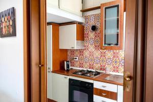 a small kitchen with a stove and a sink at La Valle e il Mare - San Leone in San Leone