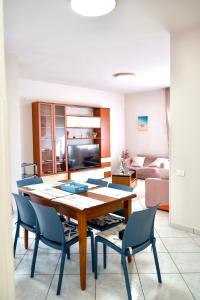 a living room with a wooden table and chairs at La Valle e il Mare - San Leone in San Leone