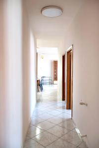 a hallway with white walls and a tile floor at La Valle e il Mare - San Leone in San Leone