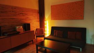 a living room with a couch and a table at Zaļais namiņš in Ventspils