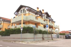 a large building on the side of a street at San Pietro D'Orio Apartment in Grado