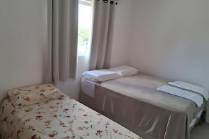 a room with two beds and a window at Panoramic Camarás Forest in Camaragibe +50 photos