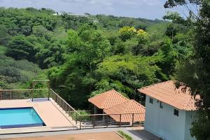 a house with a swimming pool on top of it at Panoramic Camarás Forest in Camaragibe