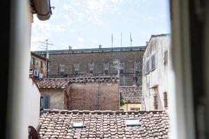 a view of an old building from a window at Florence F&M Via Maggio in Florence