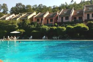 a large swimming pool with a group of houses at La Casa 44 in Soviore