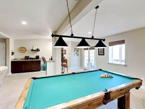 a pool table in the middle of a living room at High Expectations in Ruidoso
