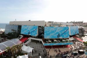 a crowd of people standing in front of a building at L'Esterel in Cannes