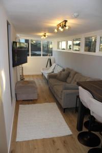 a living room with a couch and a tv at Finlays at Holme in Holmfirth
