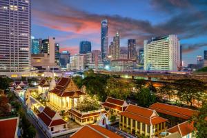 a city skyline at night with tall buildings at Banthat Thong Hostel in Bangkok