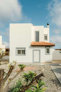 a white house with a red roof at Gennadi Dreams Ferienvilla in Gennadi +20 photos
