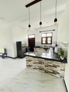 a kitchen with a counter top in a room at Hikka Garden Villa in Hikkaduwa