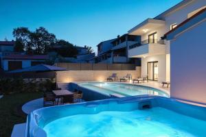 a swimming pool in the backyard of a house at Villa Cascada in Muntić