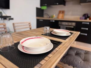 a wooden table with plates and bowls on top of it at La Dea Bendata in Rocca Priora