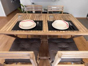 a wooden table with plates and napkins on it at La Dea Bendata in Rocca Priora