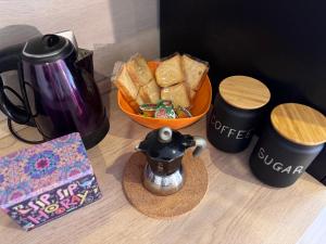 a table with a coffee pot and a bowl of bread at La Dea Bendata in Rocca Priora