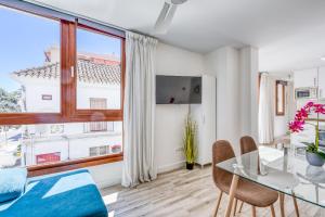 a dining room with a glass table and a large window at Apartamentos Donato Vista Mar by Croma in Estepona
