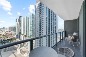 a balcony with chairs and a view of a city at Luxury 2-Bdrm Condo in the Heart of Downtown Miami in Miami