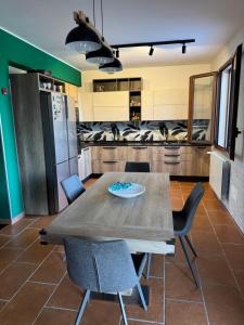 a kitchen with a wooden table and chairs at Residenza Pozzillo in Cinisi