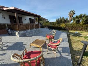 a group of chairs and a table on a patio at Residenza Pozzillo in Cinisi