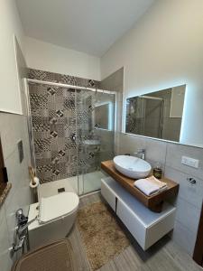 a bathroom with a toilet and a sink and a shower at Residenza Pozzillo in Cinisi +30 photos